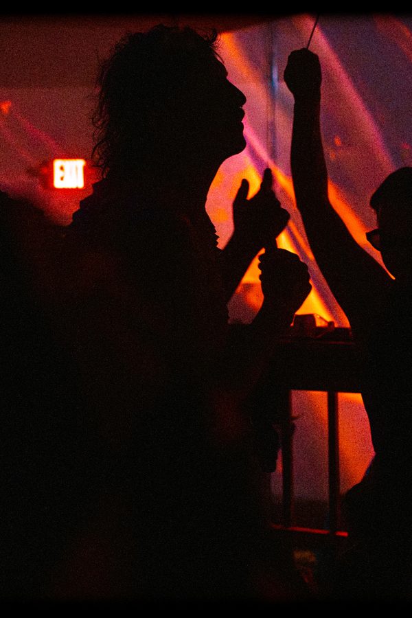 black label radio — hands up against the orange wash